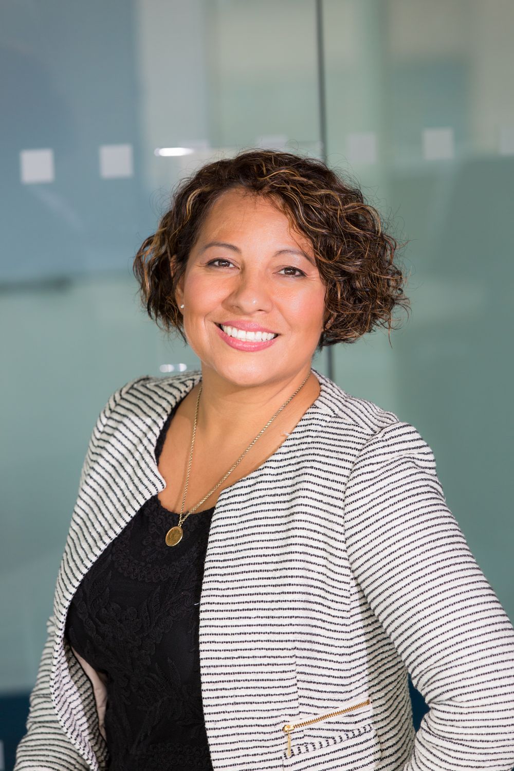 Marisol, smiling in a striped blazer