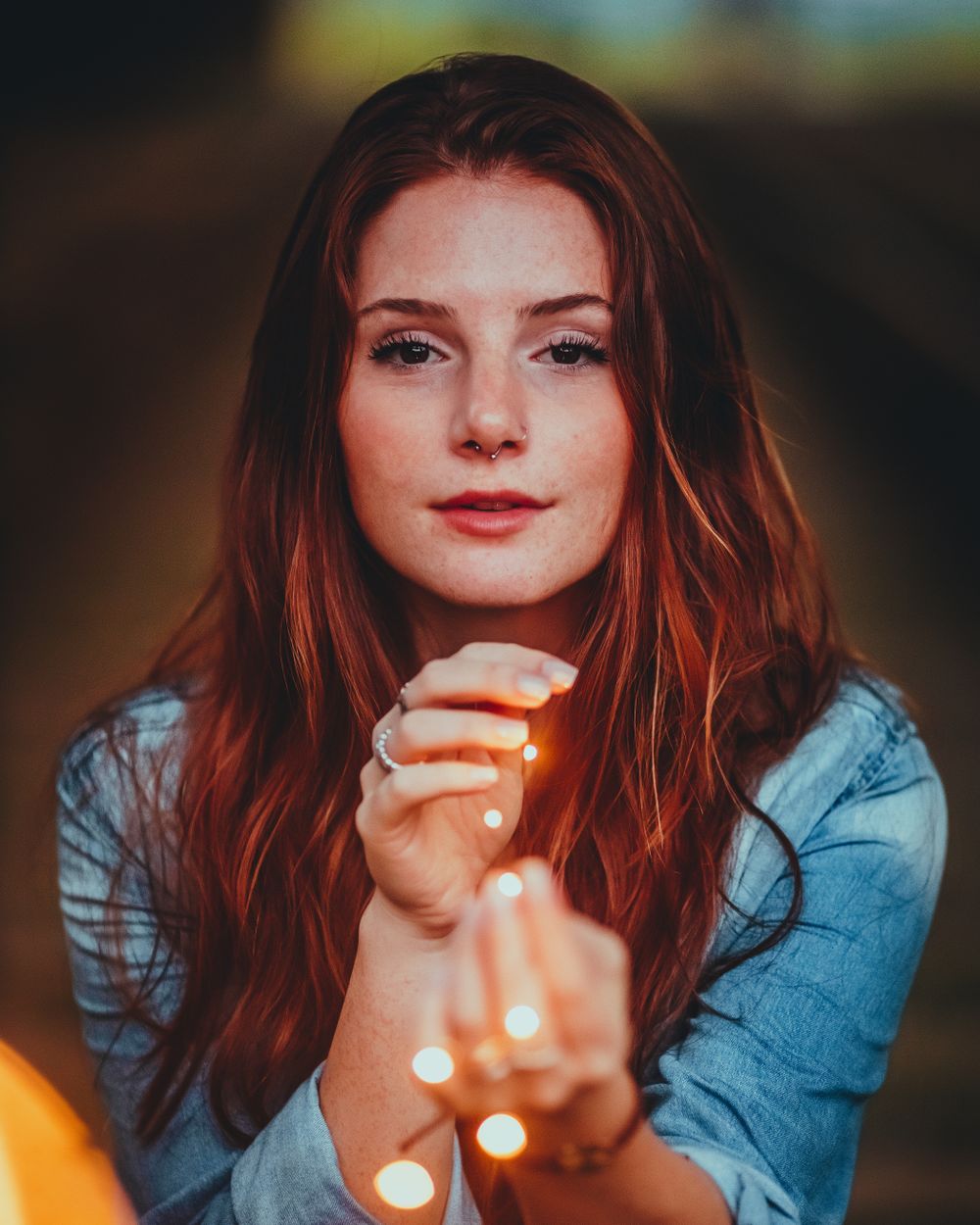 Rachel, holding a strand of warm string lights